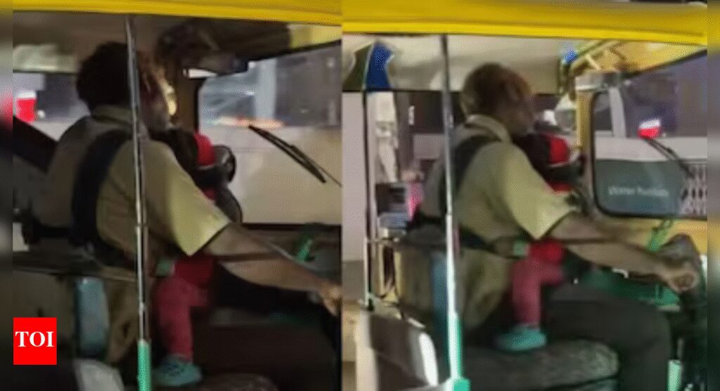 Baby in one arm, wheel in the other: Auto driver cradles infant while driving; video goes viral | India News