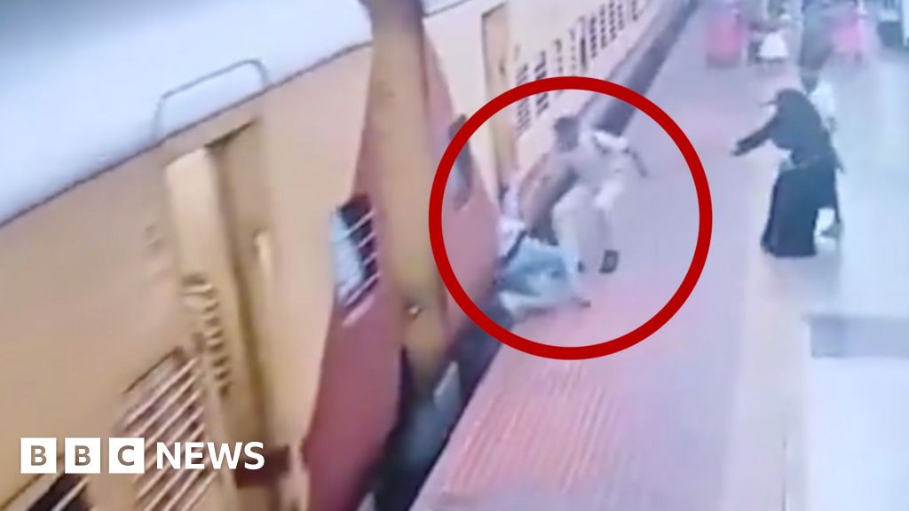 Policeman saves woman after she slipped while boarding a moving train