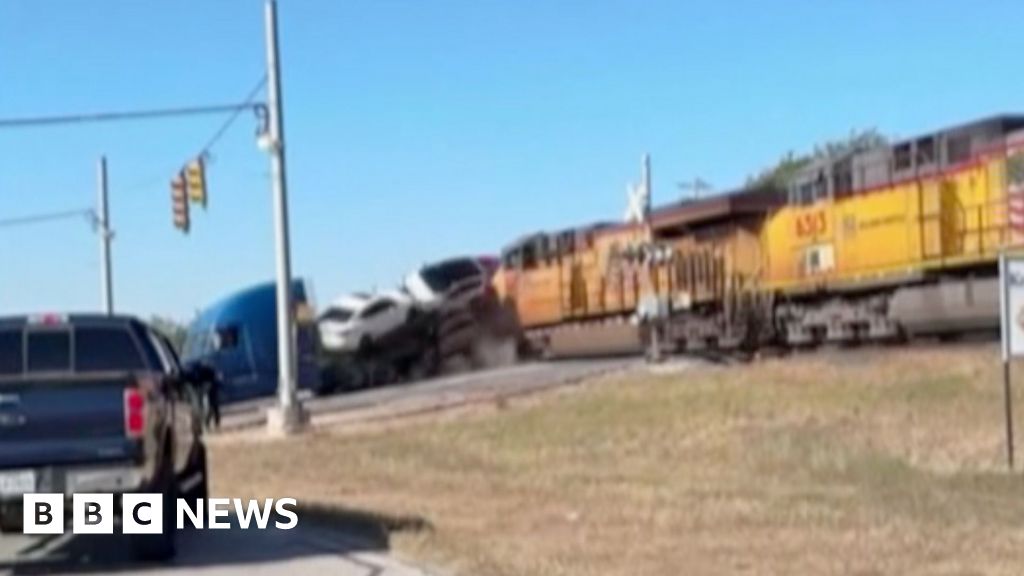 Moment train collides with lorry carrying vehicles in Texas