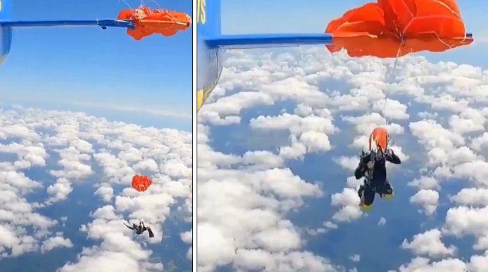Skydiver dangling 15,000 feet after parachute snags plane in terrifying viral video